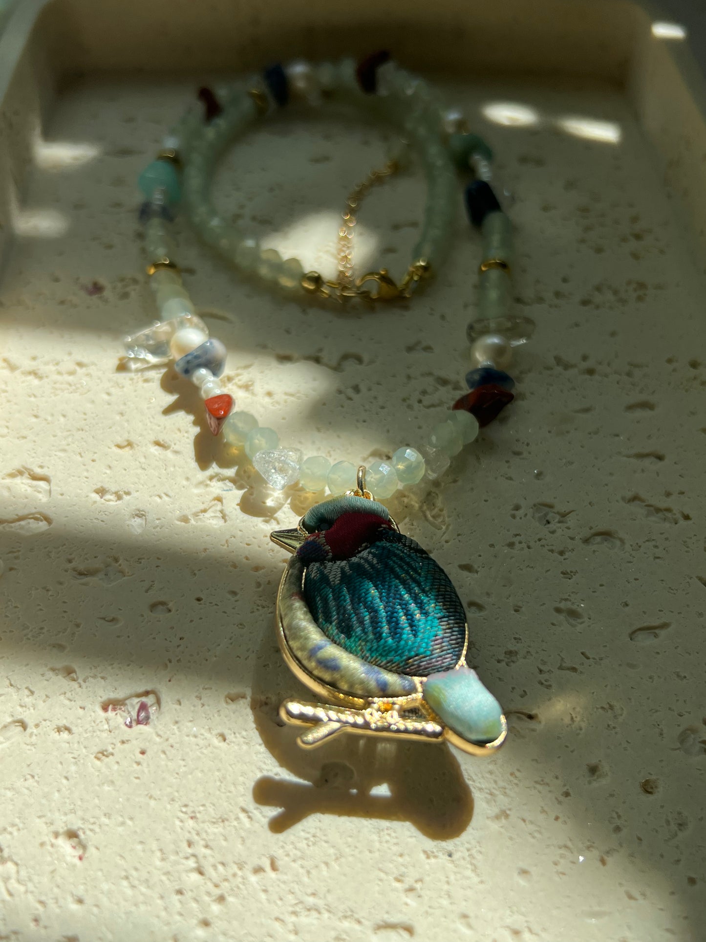 Handmade beaded necklace with freshwater pearls and colorful natural stone beads