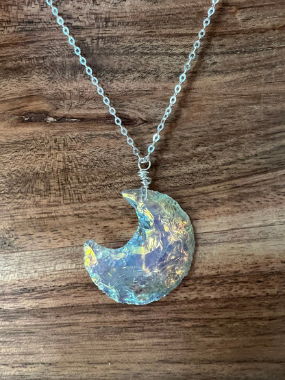 Angel aura quartz moon pendant showing rainbow color shift - wire wrapped artisan necklace