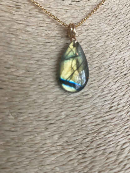 Blue labradorite teardrop necklace close-up showing natural stone flash and wire wrapping detail