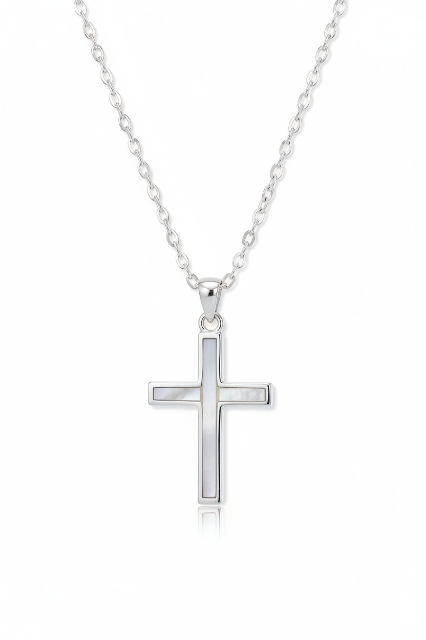 Close-up of mother of pearl inlay on sterling silver cross pendant