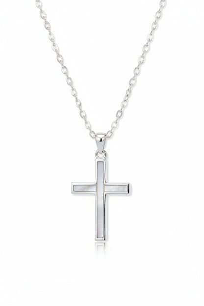 Close-up of mother of pearl inlay on sterling silver cross pendant