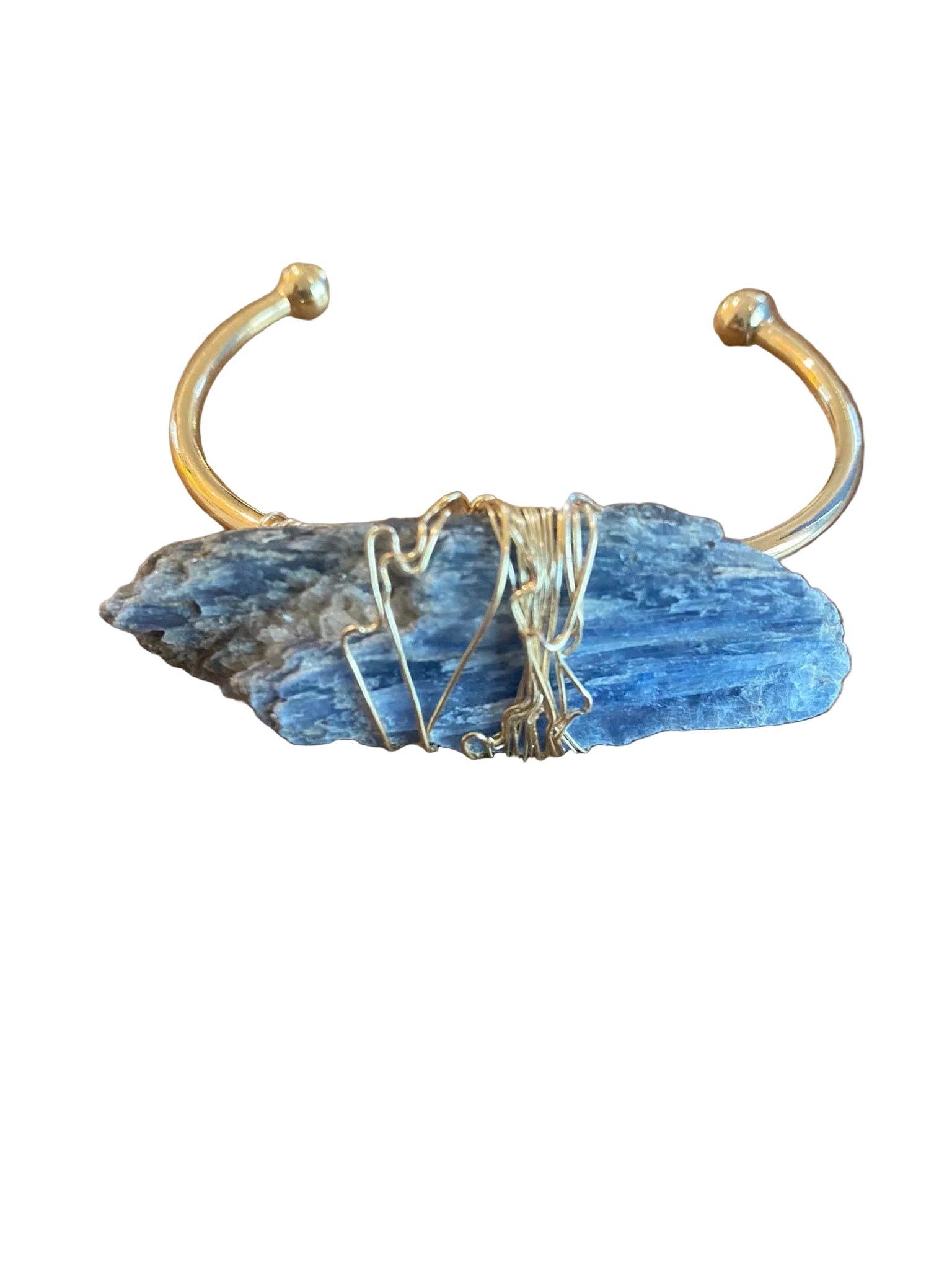 Close up of kyanite gemstone in wire wrapped cuff bracelet