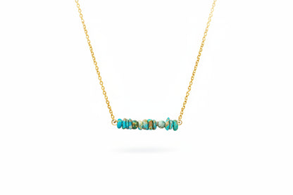 Natural turquoise bar necklace close-up showing genuine stone beads and gold chain detail