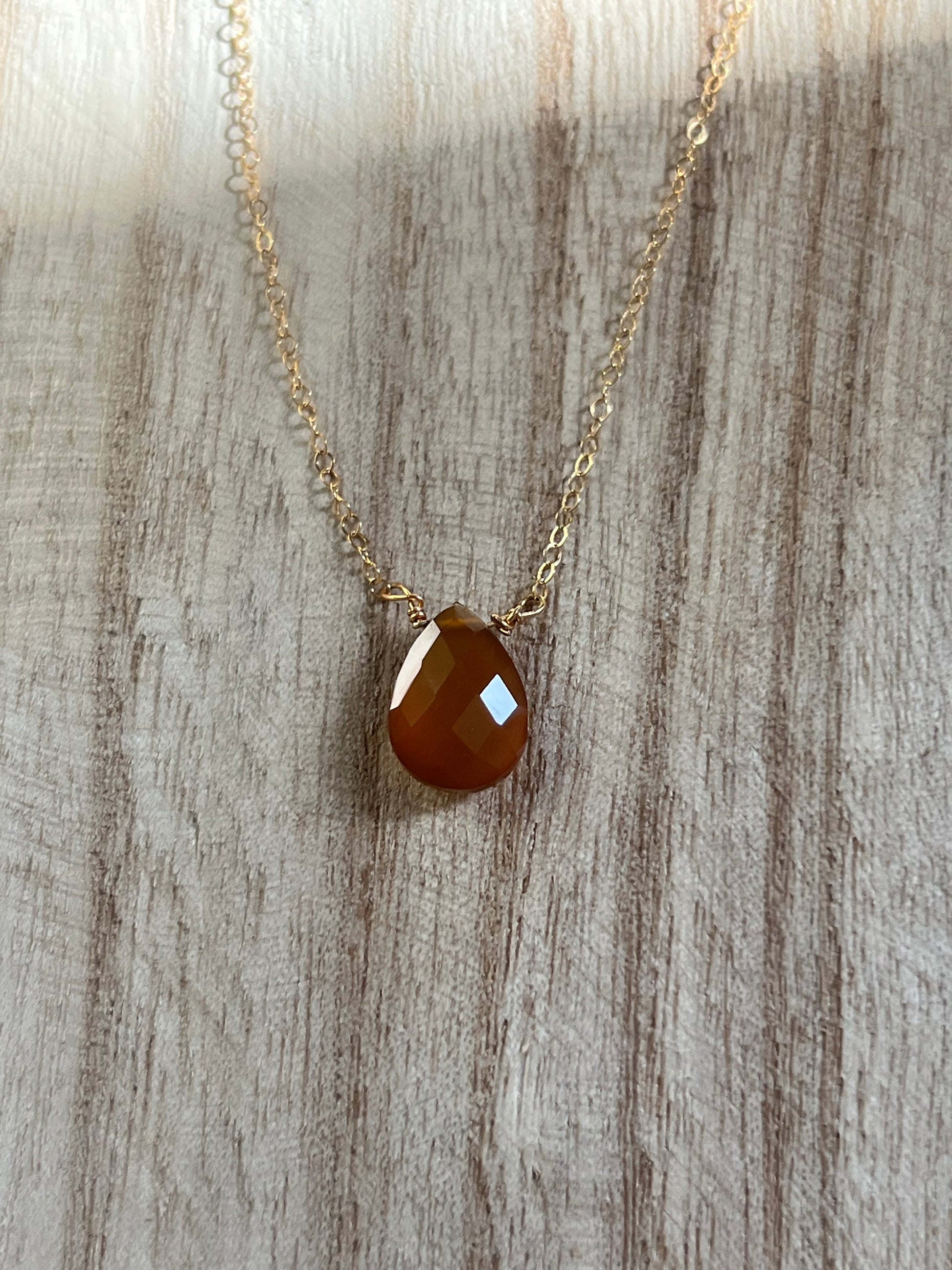 Natural yellow onyx stone pendant close-up, wire wrapped dainty gemstone necklac