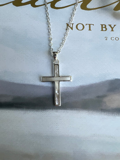 Sterling silver mother of pearl cross necklace on white background