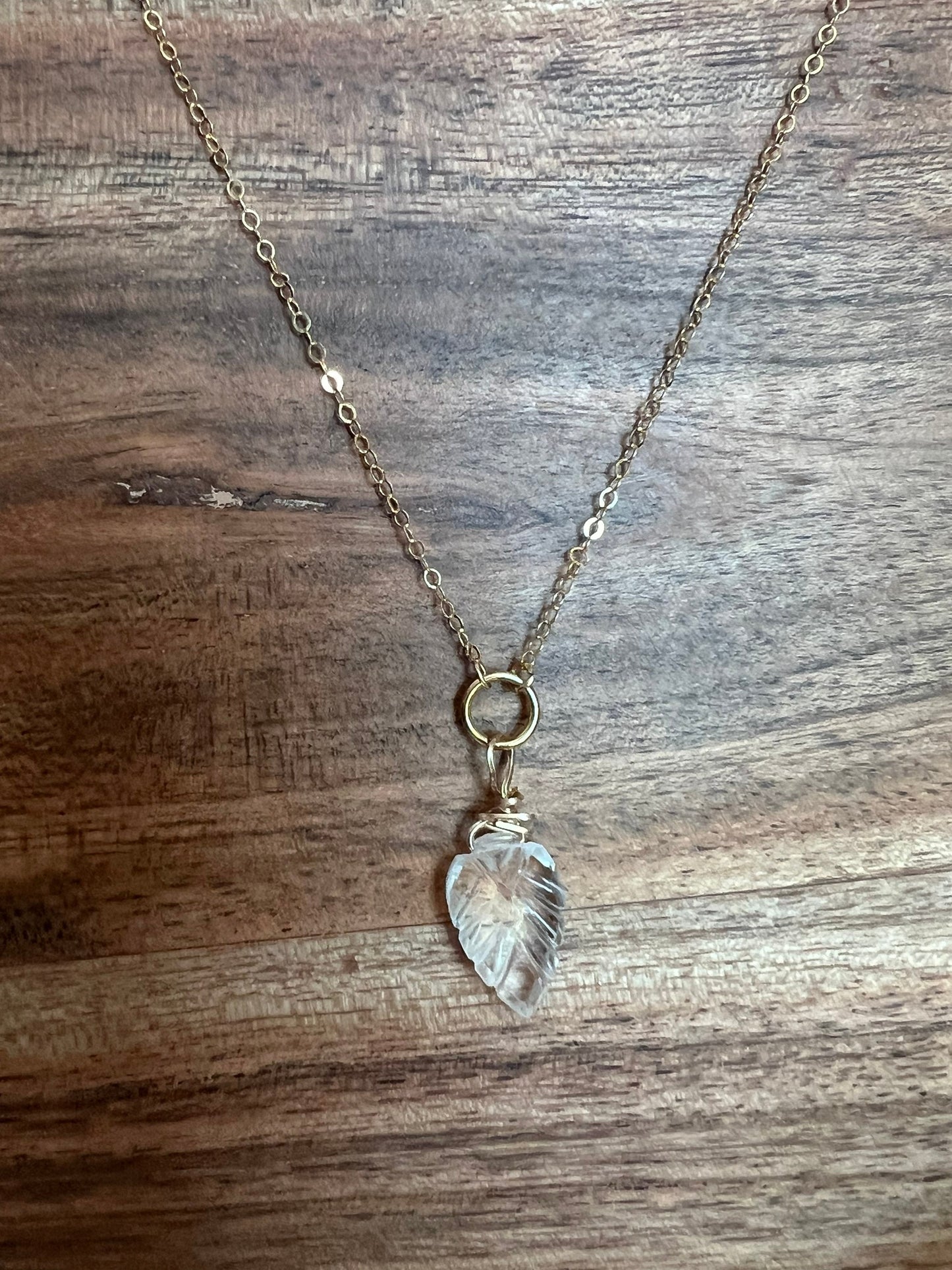 Wire wrapped quartz leaf necklace close-up showing artisan craftsmanship and natural stone clarity