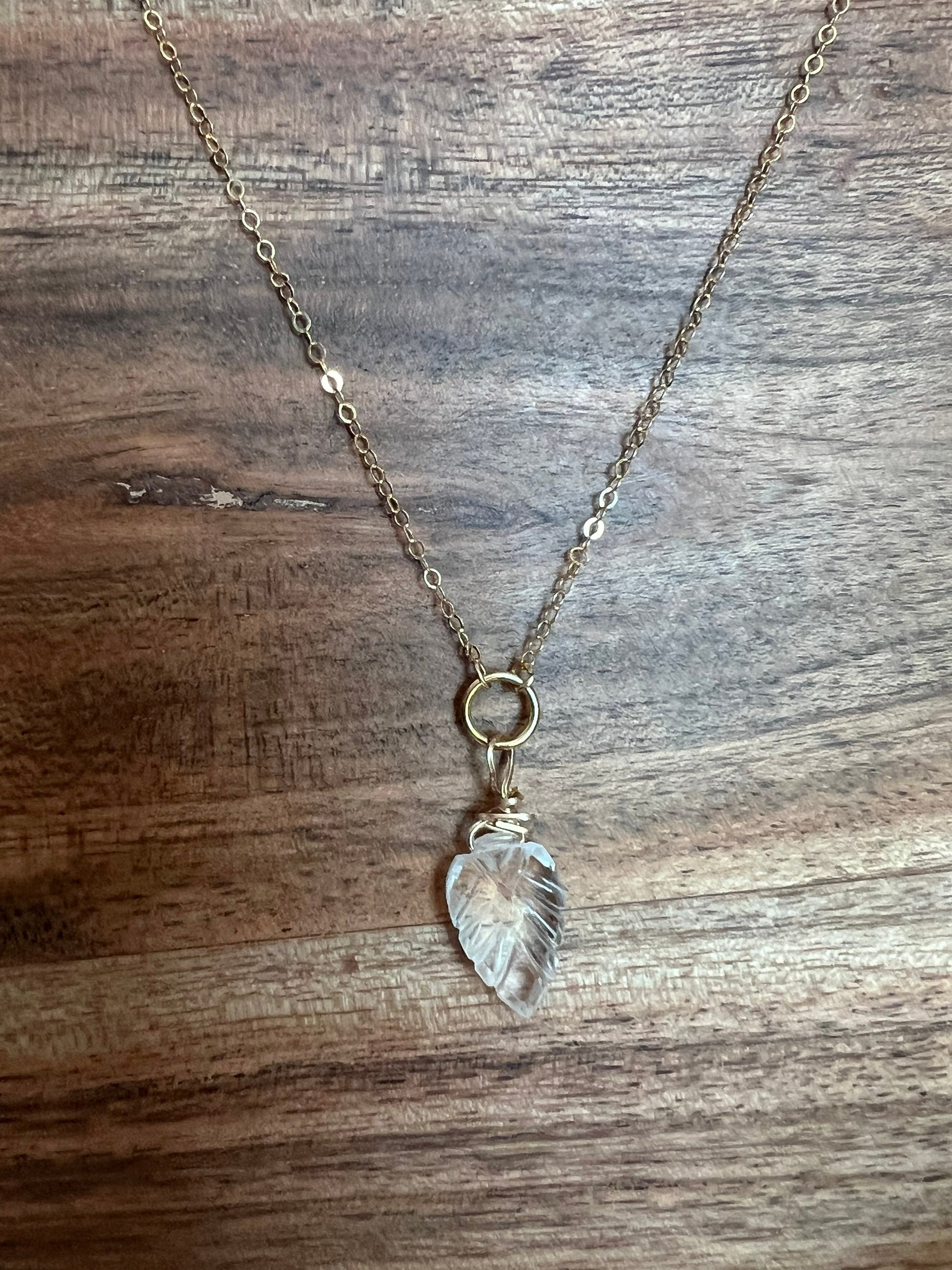 Wire wrapped quartz leaf necklace close-up showing artisan craftsmanship and natural stone clarity